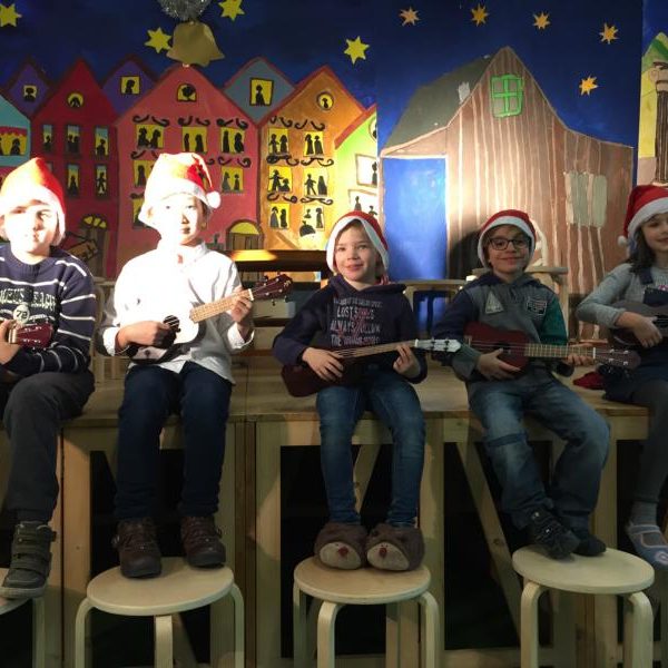 5 Kinder bei der Weihnachtsaufführung am musizieren